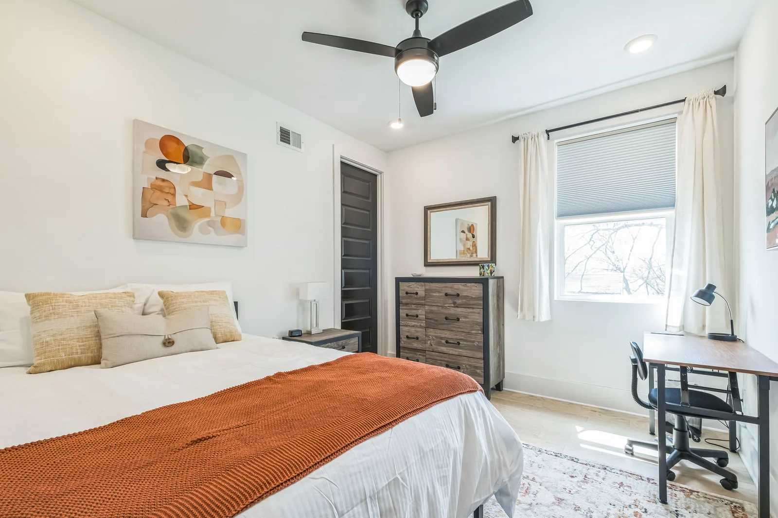 A bright, well-appointed bedroom at Tharros House Nashville